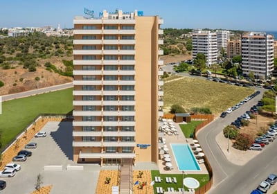 Exterior of Wyndham Residences Alvor Beach, a modern building with pool and parking 