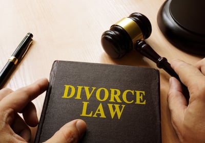 A divorce law book with pen and gravel