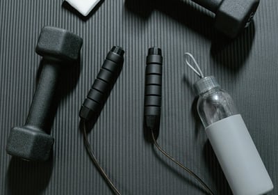 gym equipment dumbells and bottle