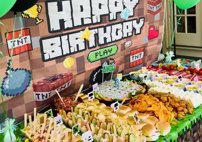 a table with a bunch of food and balloons