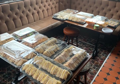 a table with trays of food in a pub