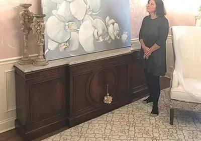 marcine standing next to orchid painting in pennington nj