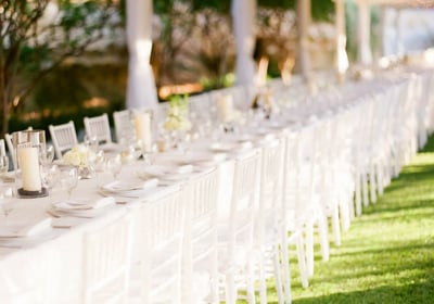 a long table with white chairs and tables