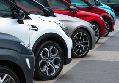 a row of parked cars with a line of parked cars, ready for rent, airport transfer, chauffeur service