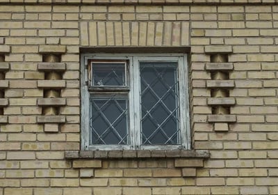 a brick building with an outdated window