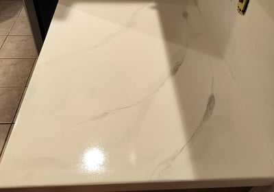 Custom white epoxy countertop with marble-style veining – seamless, glossy finish ideal for kitchens