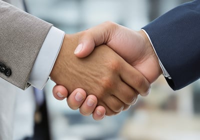 two people shaking hands with each other