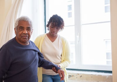 physiotherapy at home for seniors - an elderly man looking happy to be helped by The London Physio