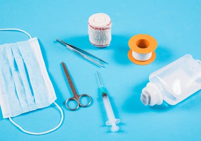 a variety of medical supplies including a bottle of liquid