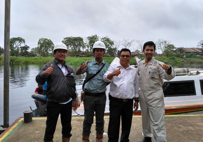 a group of men standing after Buy Oil Boom