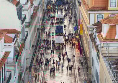 a city street scene with people walking down a street