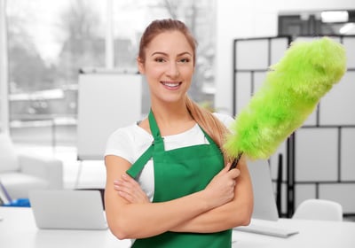 a woman in green aprons holding a green duster