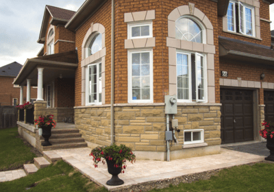 a house with a large window and a potted planter