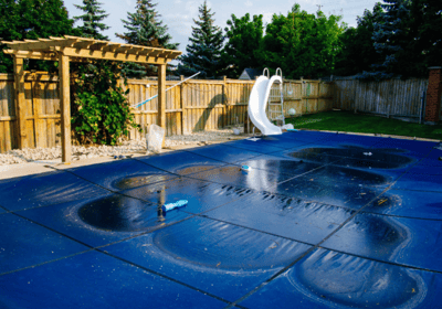 a pool with a slider and a slider in the middle of the pool