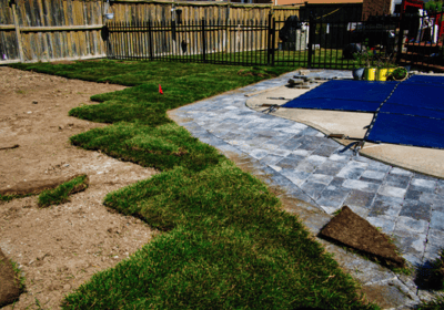 a backyard patio with a blue tarp and a blue tarp