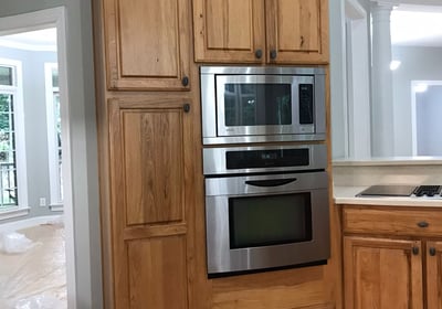 a kitchen with a stove and oven in it