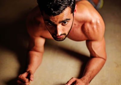 a man doing push ups on a floor
