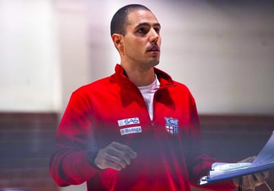 a man in a red jacket is holding a piece of paper