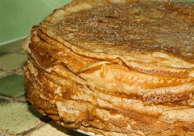 a stack of pancakes with cinnamon syrup on a plate