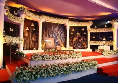 Elegant floral wedding stage backdrop with soft lights by Amika Weddings, Pune-based wedding decorators