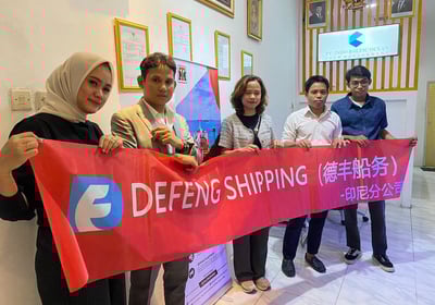 a group of people holding a banner that says defend shipping