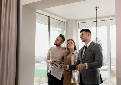 A Realtor in a home with sellers explaining the home selling process 