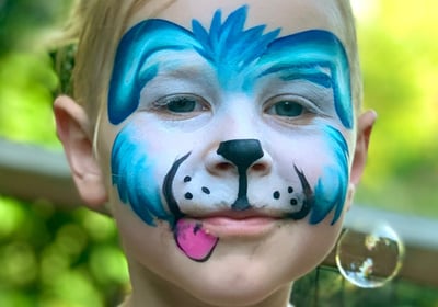 Child with face paint of a blue puppy dog. 