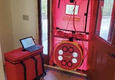 Retrotec blower door testing equipment testing to see how leaky a building envelope is.