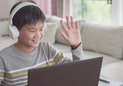 a boy with headphones and headphones on a couch
