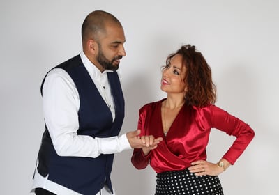 Une homme invite une femme à danser de manière élégante et avec un joli sourire