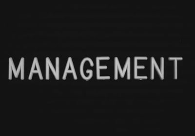 a black and white sign that says management