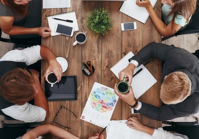 a group of people sitting around a table