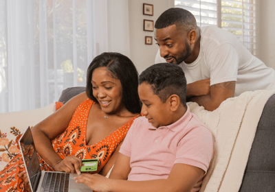 a family sitting on a couch in a living room