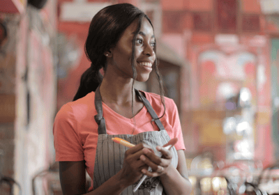 a woman in a apron and aprons holding a carrot