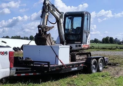 Mini excavator loaded on a trailer