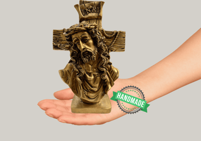 a hand holding a cross on a hand