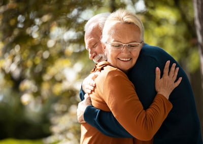 a man and woman are hugging and smiling