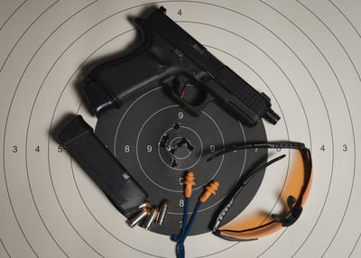 Glock Handgun, Ear plugs, safety glasses and range target for accuracy