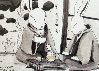 deux lapins japonais qui prennent le thé