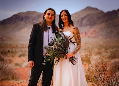 a man and woman standing in the desert