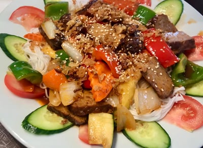 a plate of food with vegetables and tempeh