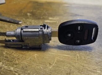 New car key in ignition, representing ignition repair and replacement service