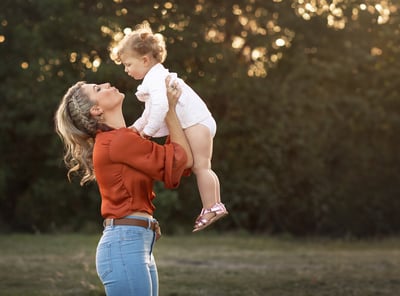 a woman holding a baby in her arms