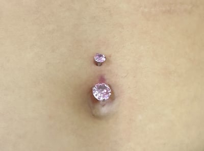 Navel pierced with a double gem barbell