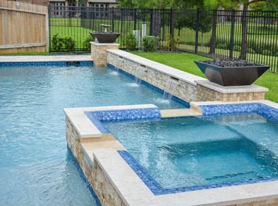Close-up of luxury pool tile and cascading water feature in a Palo Alto backyard