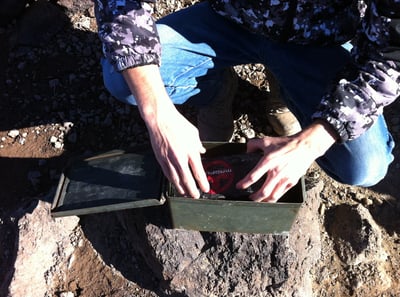 Steven opens a register box atop Black Mountain in Nevada