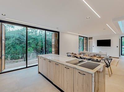 a kitchen with a large window and a table with chairs