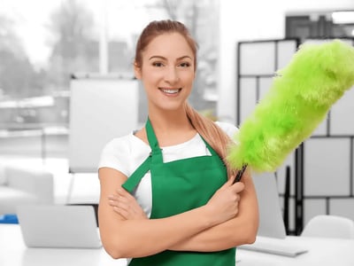 a woman in green aprons holding a green duster