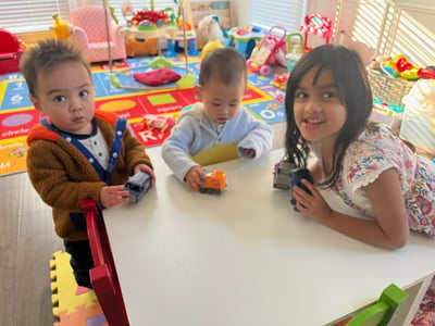 Photo of three young children playing in the daycare.