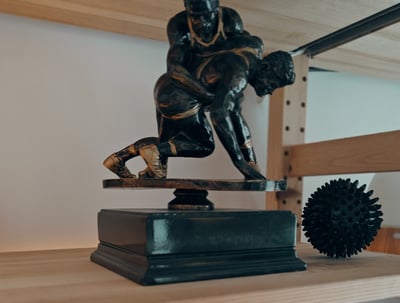 a statue of a man wrestling on a shelf